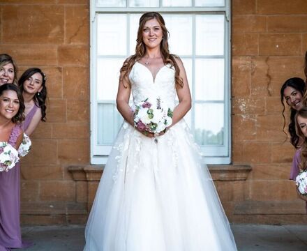 Kelly & bridesmaids under arches